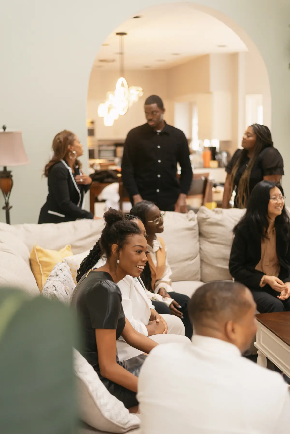 A living room full of women laughing during a gathering.